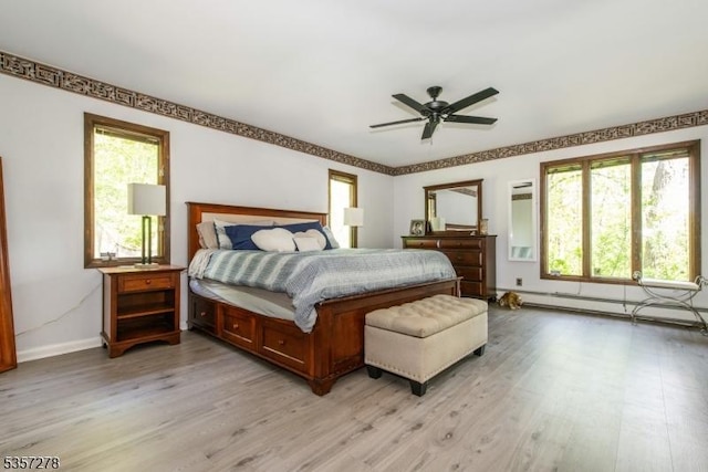 8 Reger Rd, Chester Twp, NJ 07836 - bedroom with a baseboard heating unit, light wood-type flooring, multiple windows, and baseboards