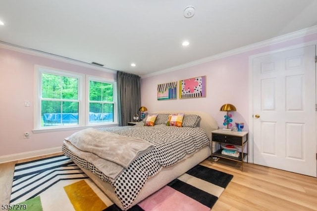 bedroom featuring crown molding, wood finished floors, and recessed lighting