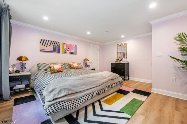 bedroom featuring recessed lighting, wood finished floors, baseboards, and ornamental molding
