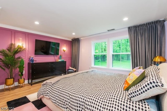 bedroom featuring crown molding, wood finished floors, and recessed lighting