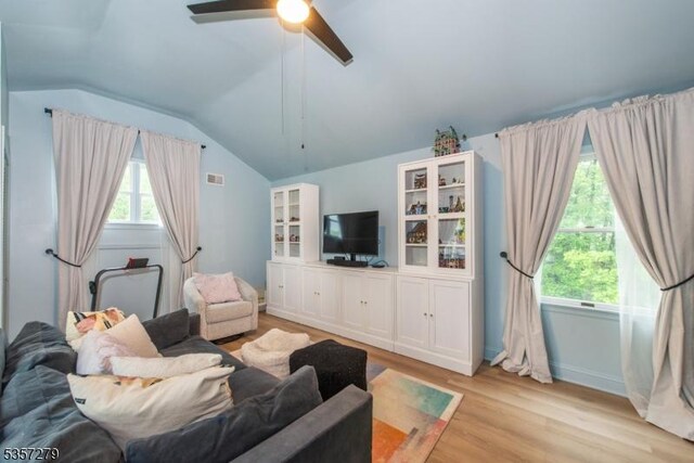 living room featuring light wood finished floors, lofted ceiling, and ceiling fan