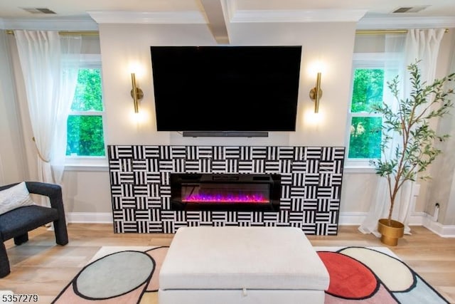 living room with crown molding, wood finished floors, and baseboards