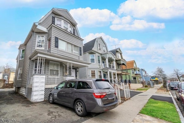 multi unit property featuring a residential view and a porch