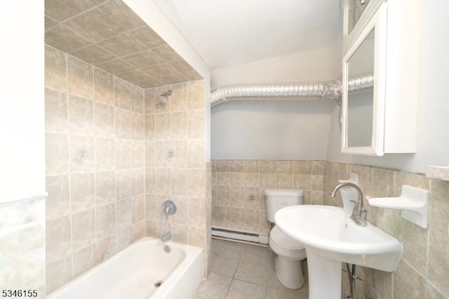 full bath featuring a baseboard heating unit, tile walls, toilet, tile patterned flooring, and shower / washtub combination