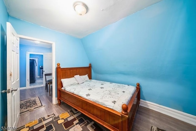 bedroom with wood finished floors and baseboards