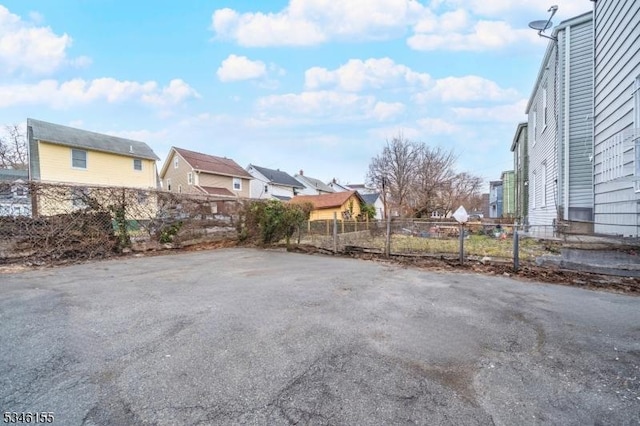view of yard featuring fence and a residential view