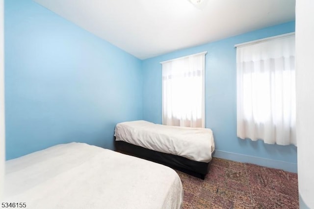 bedroom featuring carpet floors and baseboards