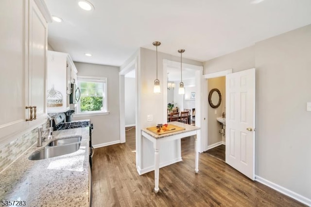 188 Watchung Ter, Scotch Plains Twp, NJ 07076 - kitchen featuring white cabinets, dark wood-style floors, pendant lighting, light stone counters, and stainless steel gas range oven