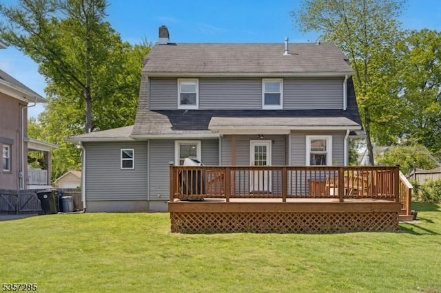 rear view of property featuring a wooden deck and a chimney
