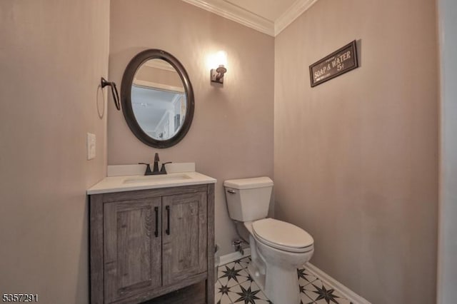 half bath with crown molding, toilet, baseboards, vanity, and tile patterned flooring