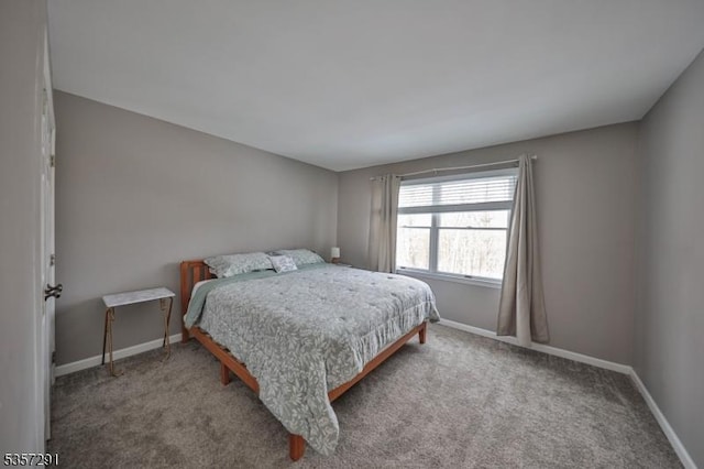carpeted bedroom featuring baseboards