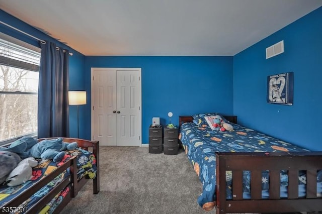 carpeted bedroom featuring a closet