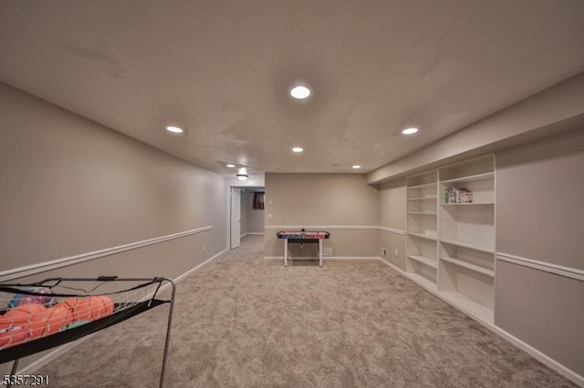 finished below grade area with recessed lighting, carpet flooring, baseboards, and built in shelves