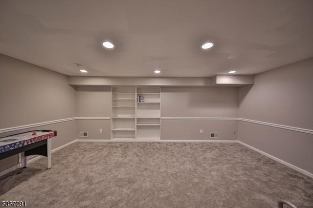 finished below grade area with carpet floors, baseboards, and recessed lighting