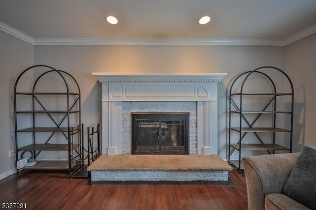 detailed view of wood finished floors, ornamental molding, a tile fireplace, baseboards, and recessed lighting
