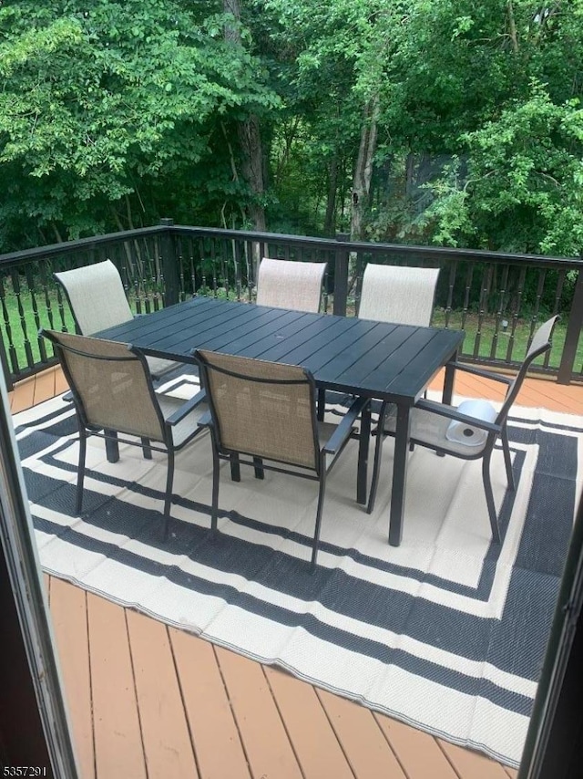 wooden terrace with outdoor dining space