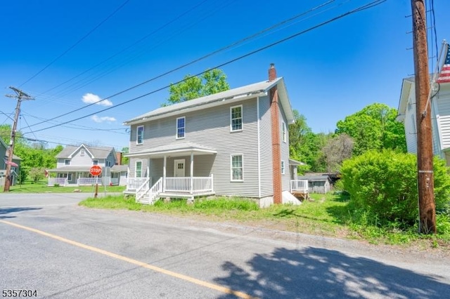 571 Main St, Union Twp, NJ 08802 - view of front facade featuring a porch and a chimney