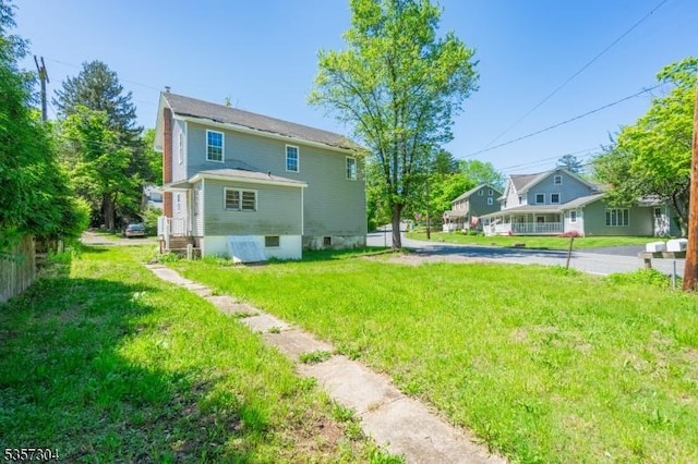 571 Main St, Union Twp, NJ 08802 - rear view of house with a yard