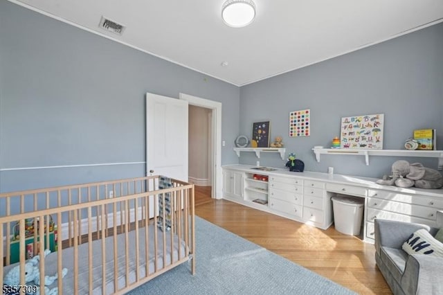bedroom featuring light wood-style floors