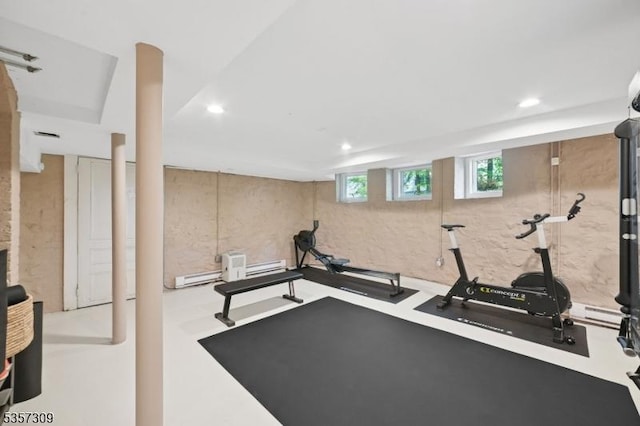 exercise room featuring recessed lighting and a baseboard heating unit