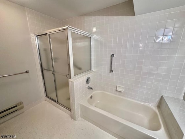bathroom with a stall shower, a bath, tile patterned floors, and a baseboard radiator