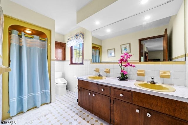 1602 Harbourton Rocktown Rd, Hopewell Twp, NJ 08530 - bathroom with double vanity, toilet, tile walls, tile patterned floors, and a wainscoted wall