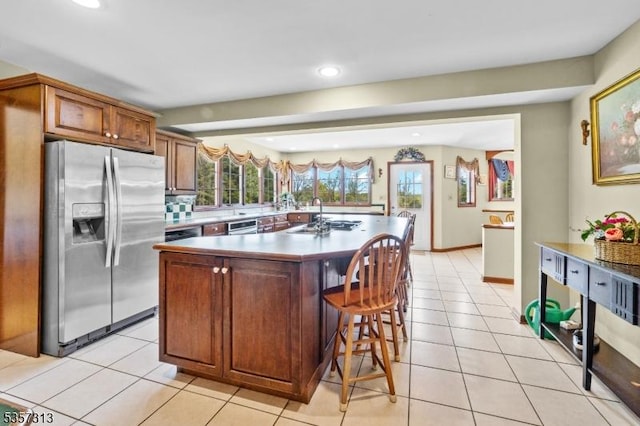 1602 Harbourton Rocktown Rd, Hopewell Twp, NJ 08530 - kitchen featuring stainless steel fridge with ice dispenser, recessed lighting, a center island with sink, a breakfast bar, and light tile patterned floors