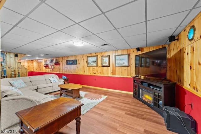 1602 Harbourton Rocktown Rd, Hopewell Twp, NJ 08530 - living room with wood walls, light wood-style flooring, a drop ceiling, and baseboards