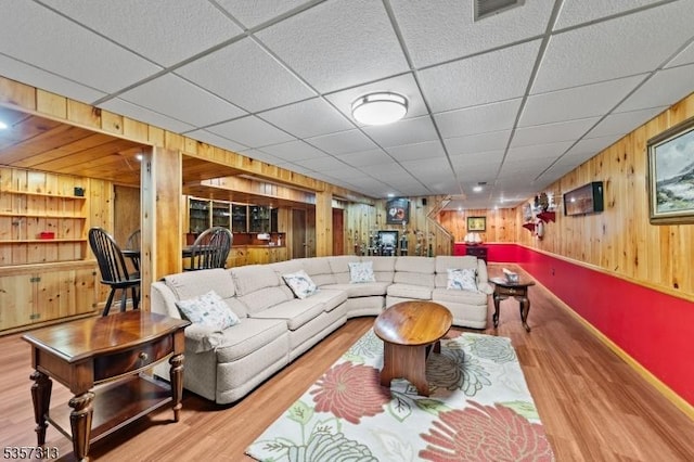 1602 Harbourton Rocktown Rd, Hopewell Twp, NJ 08530 - living room featuring wooden walls, wood finished floors, built in features, baseboards, and a drop ceiling