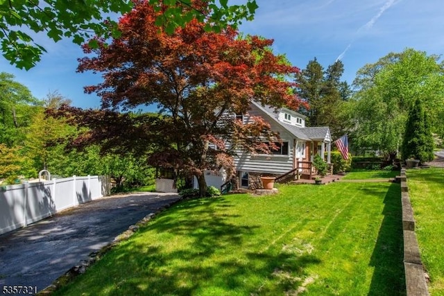 view of front facade featuring asphalt driveway