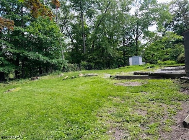 128 Upper High Crest Dr, West Milford Twp, NJ 07480 - view of green lawn featuring a storage shed