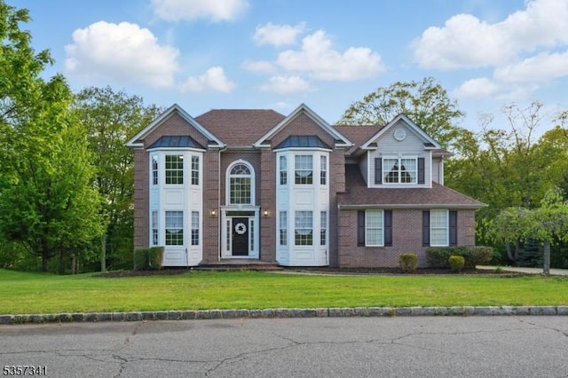 view of front of property with a front yard and brick siding