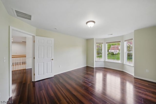 unfurnished room featuring wood finished floors and baseboards
