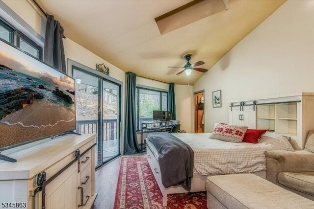 bedroom with light wood-style floors, access to exterior, lofted ceiling, and a ceiling fan