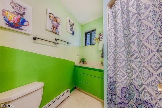 full bathroom featuring toilet, vanity, baseboard heating, curtained shower, and tile patterned floors