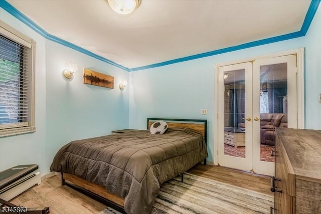 bedroom with french doors and wood finished floors