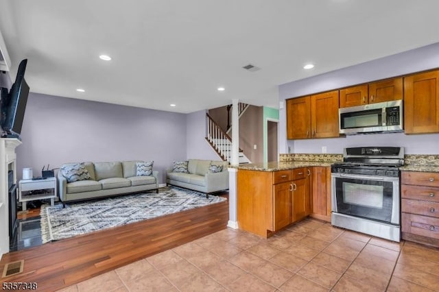 1901 Stech Dr, Bridgewater Twp, NJ 08807 - kitchen featuring stainless steel appliances, light stone countertops, open floor plan, light tile patterned floors, and recessed lighting