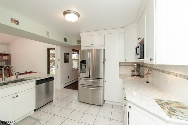 23 Horizon Dr, Roxbury Twp, NJ 07876 - kitchen featuring appliances with stainless steel finishes, a sink, baseboard heating, light tile patterned floors, and tasteful backsplash