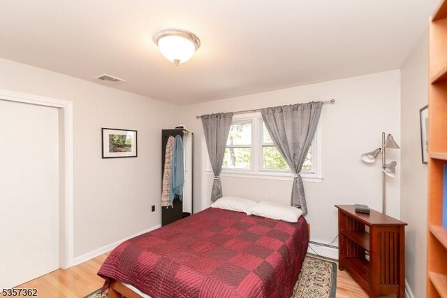 23 Horizon Dr, Roxbury Twp, NJ 07876 - bedroom featuring baseboard heating and light wood-style flooring