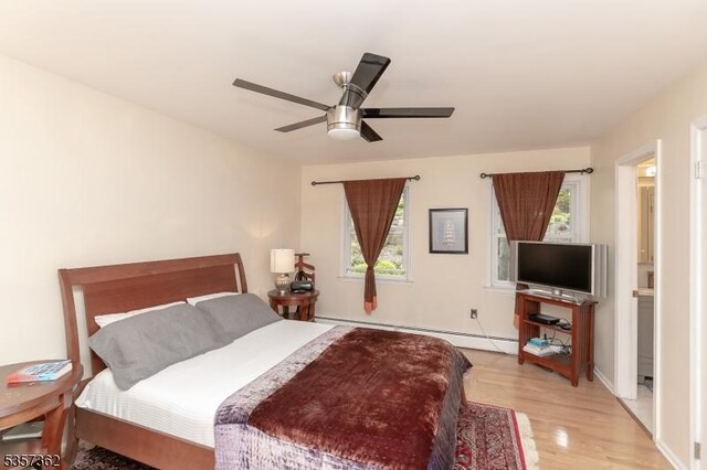23 Horizon Dr, Roxbury Twp, NJ 07876 - bedroom with a baseboard radiator, light wood-style floors, and ceiling fan