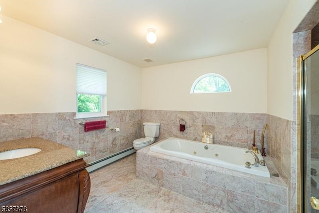 bathroom with baseboard heating, toilet, a tub with jets, vanity, and tile walls