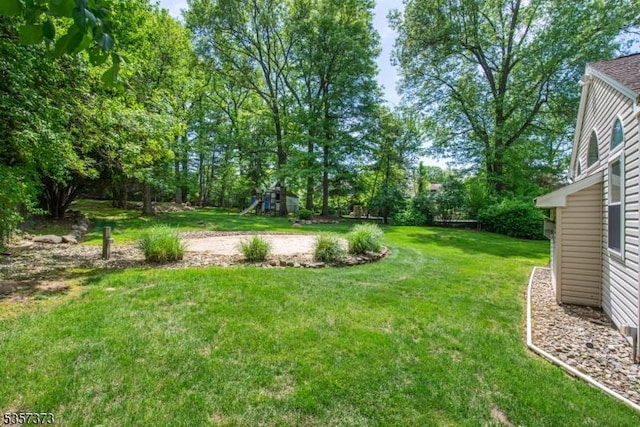 view of grassy yard featuring a playground