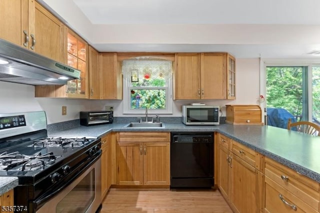 39 Circle Dr, Rockaway Twp, NJ 07866 - kitchen featuring black dishwasher, stainless steel range with gas cooktop, a sink, under cabinet range hood, and light wood-style flooring