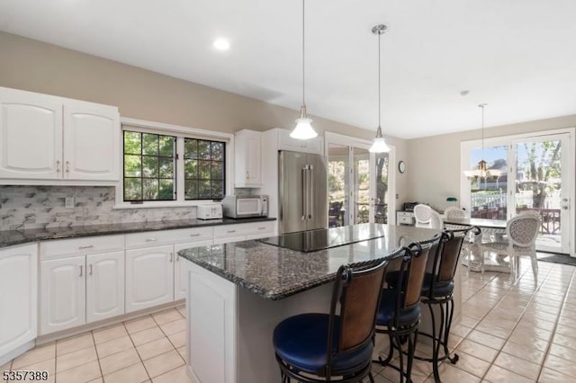 6 Wintermute Farm Ln, Tewksbury Twp, NJ 08833 - kitchen featuring white microwave, high quality fridge, black electric stovetop, a kitchen island, and light tile patterned flooring