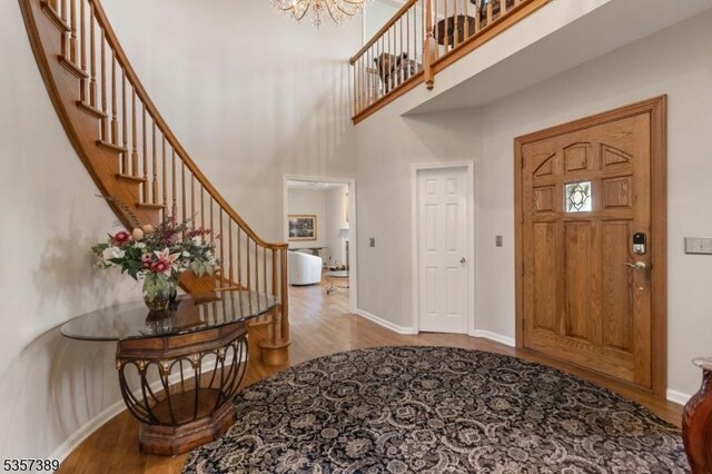 6 Wintermute Farm Ln, Tewksbury Twp, NJ 08833 - entryway with wood finished floors, stairway, a chandelier, baseboards, and a high ceiling