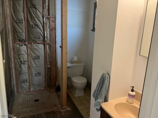 bathroom featuring toilet and vanity
