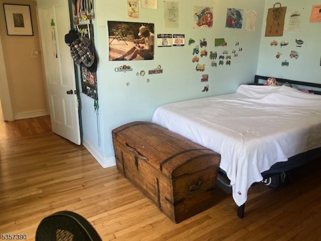 bedroom with light wood-style flooring and baseboards