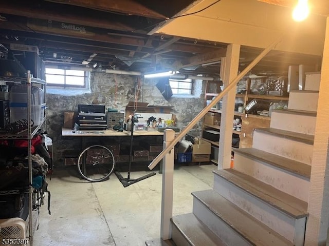 basement with a workshop area and stairway