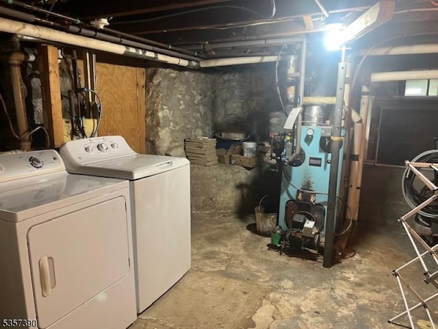 unfinished below grade area featuring washer and dryer