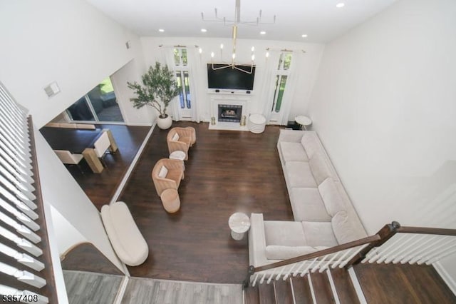 living area featuring plenty of natural light, wood finished floors, recessed lighting, and a fireplace